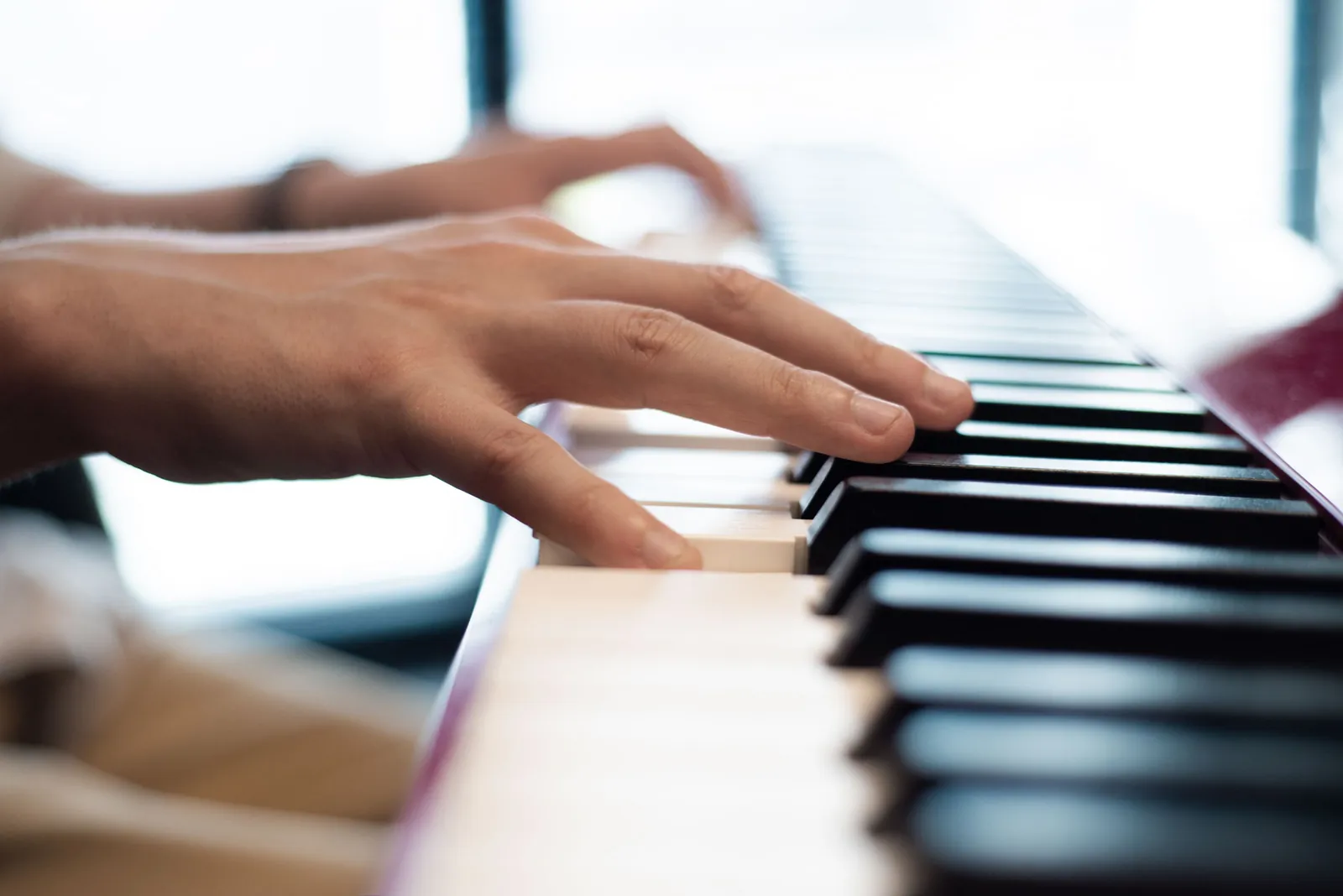Hands on the keys during a piano lesson