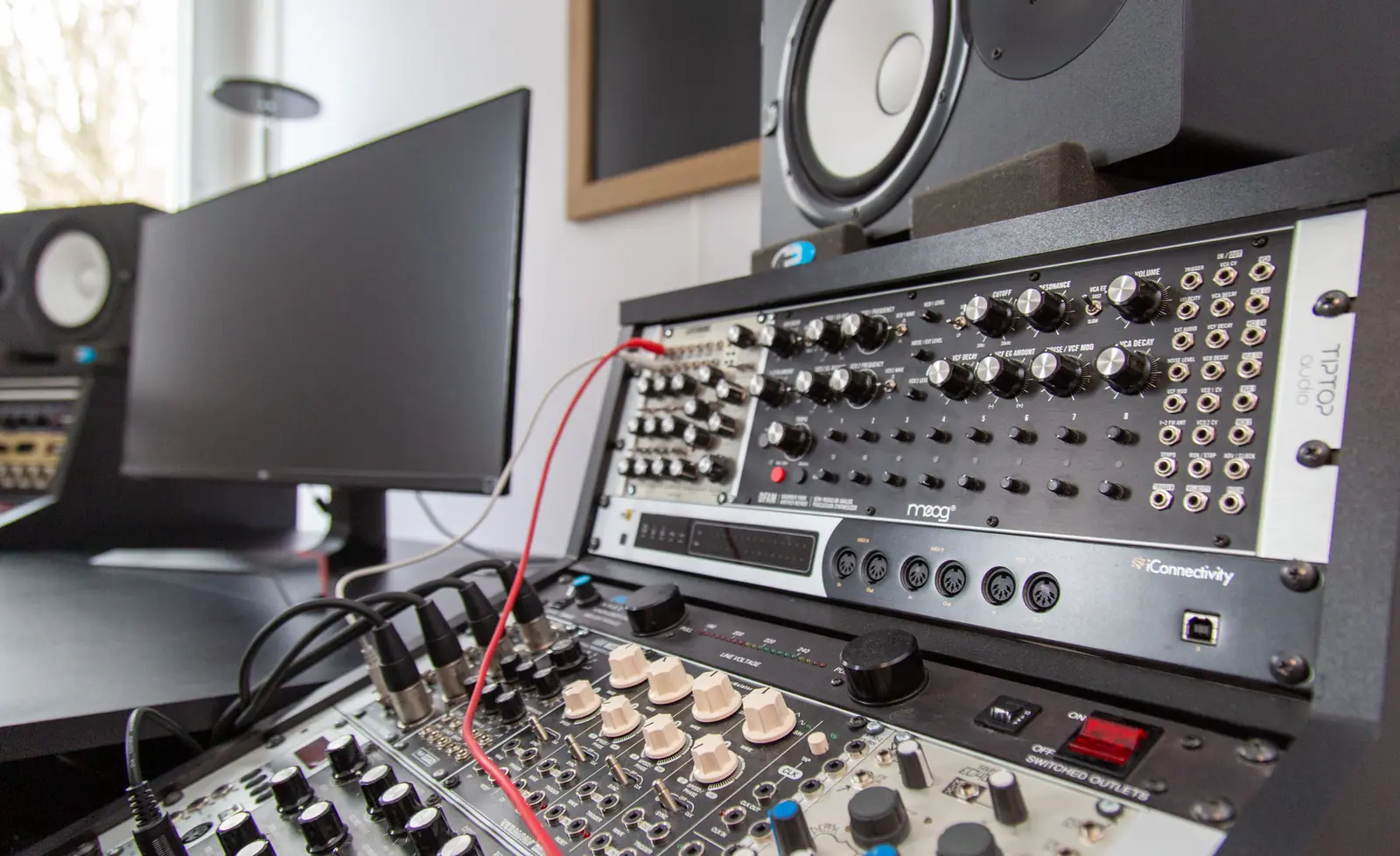 Recording studio with monitors and a synthesizer